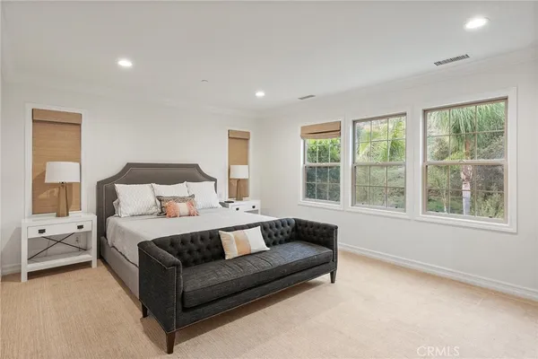 a bedroom with furniture and a flat screen tv