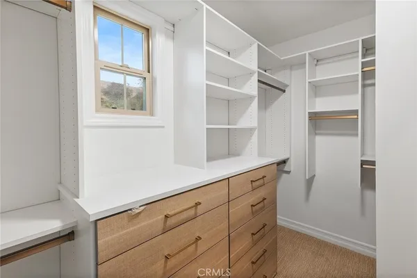 a spacious bathroom with a double vanity sink a mirror and a shower