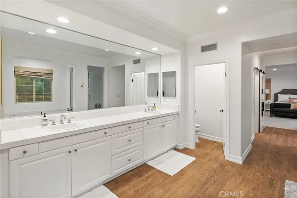 a spacious bathroom with a tub shower and a sink