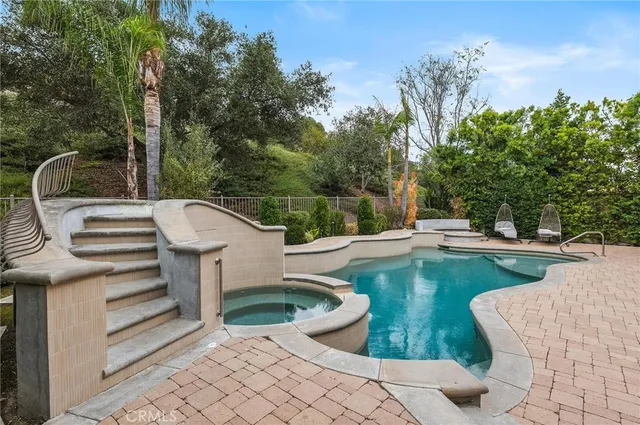 a view of a swimming pool and lounge chair