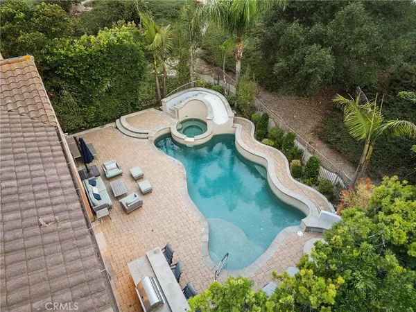 a view of a swimming pool and lounge chair