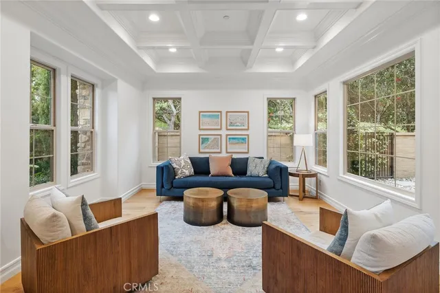 a living room with furniture and large windows