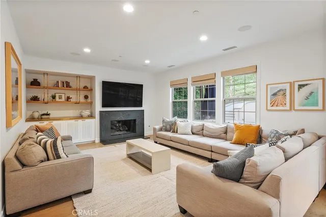 a living room with furniture fireplace and a flat screen tv
