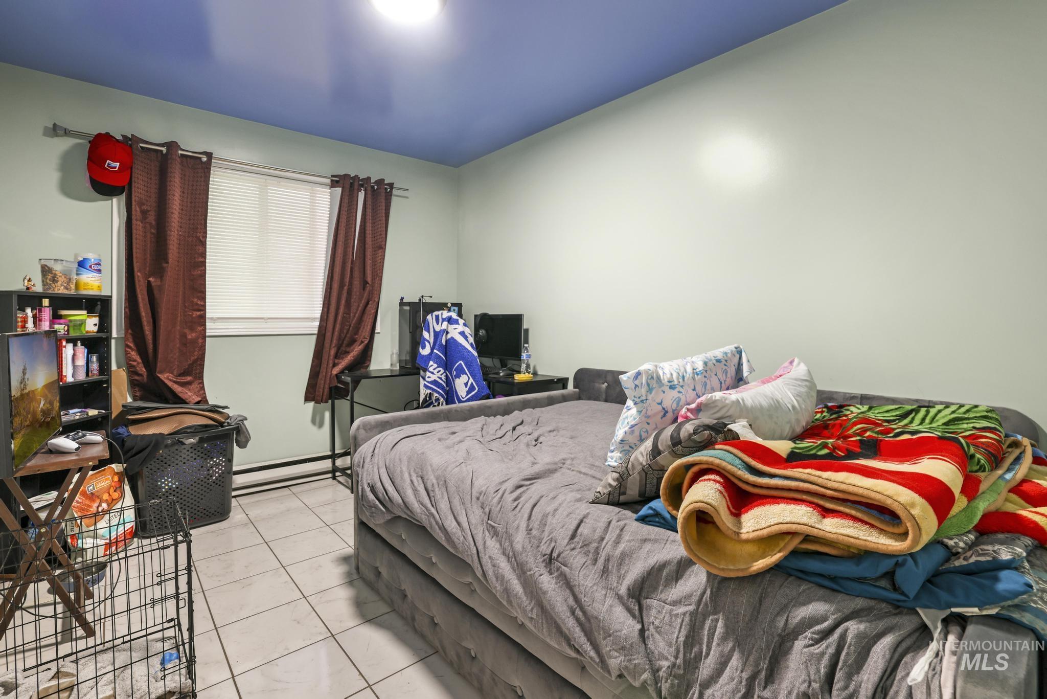 403 3rd Avenue West Jerome, ID 83338 - Photo 11 of 36 Bedroom with a baseboard heating unit and tile patterned floors