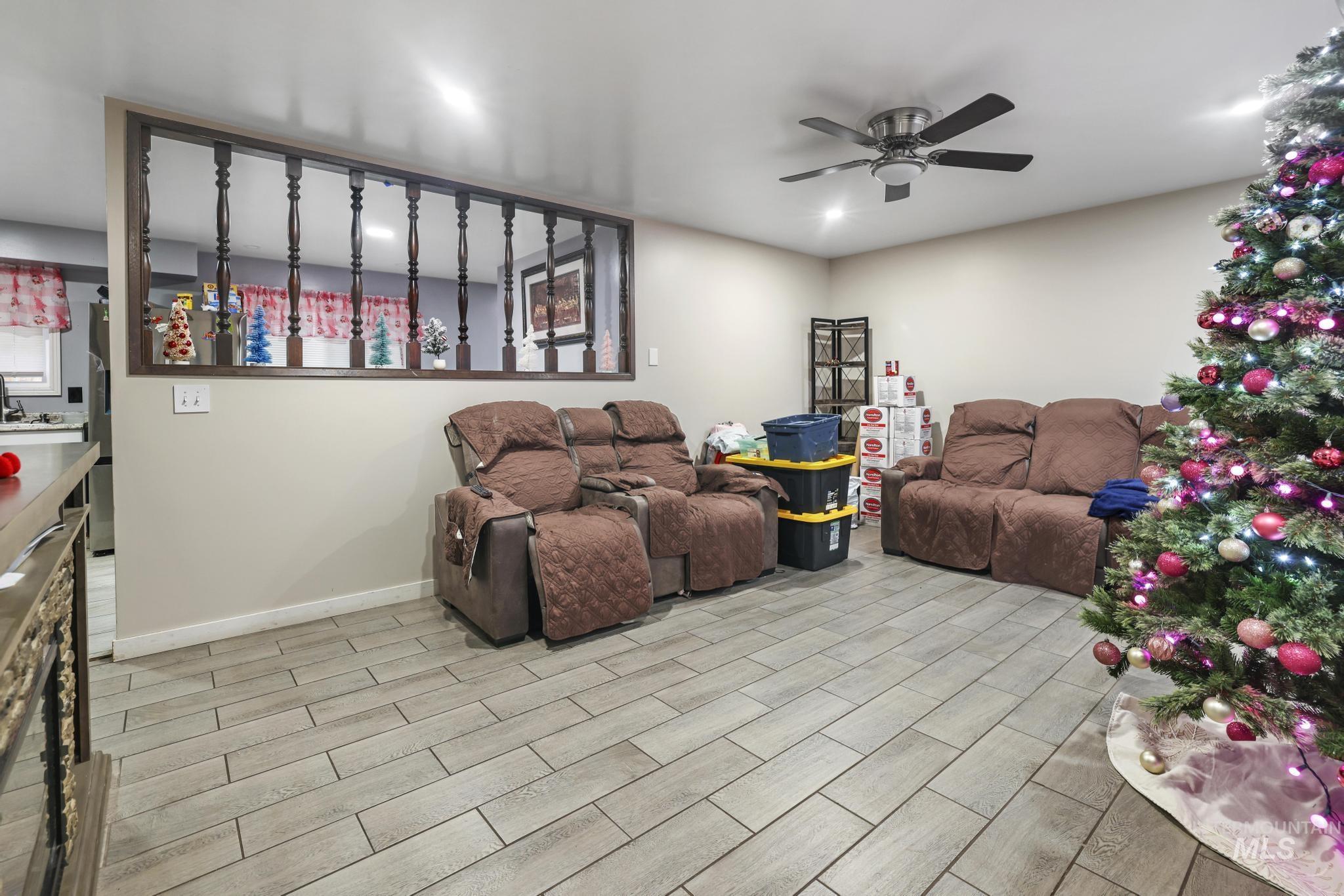 403 3rd Avenue West Jerome, ID 83338 - Photo 14 of 36 Living room featuring wood tiled floors and ceiling fan