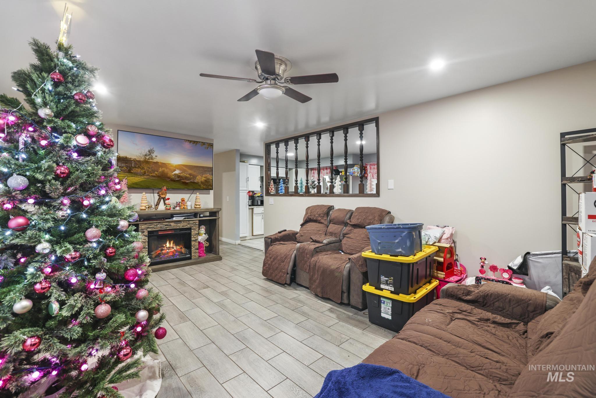 403 3rd Avenue West Jerome, ID 83338 - Photo 15 of 36 Living room with a fireplace, ceiling fan, and wood finish floors
