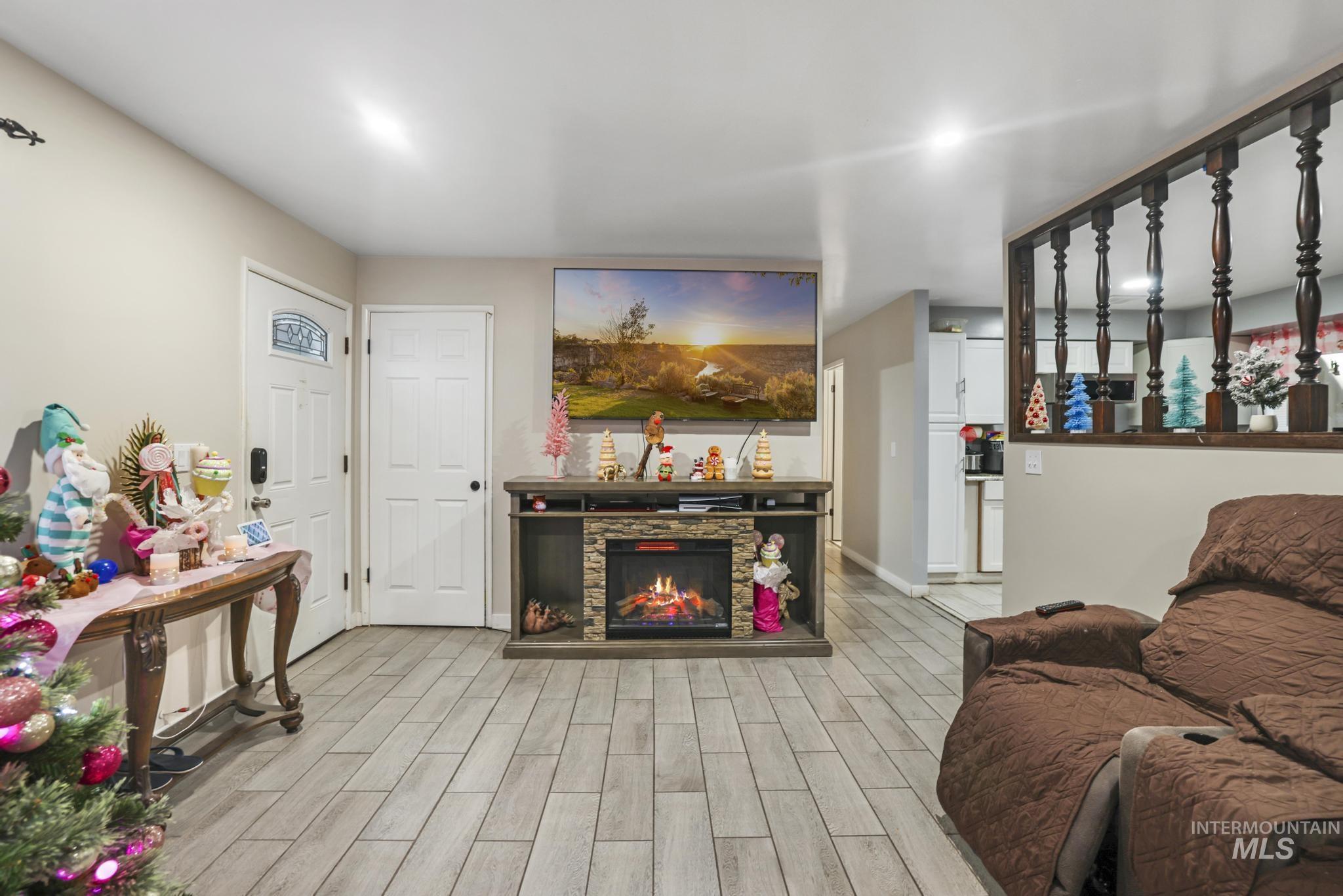 403 3rd Avenue West Jerome, ID 83338 - Photo 4 of 36 Living room with wood tiled floors and a fireplace