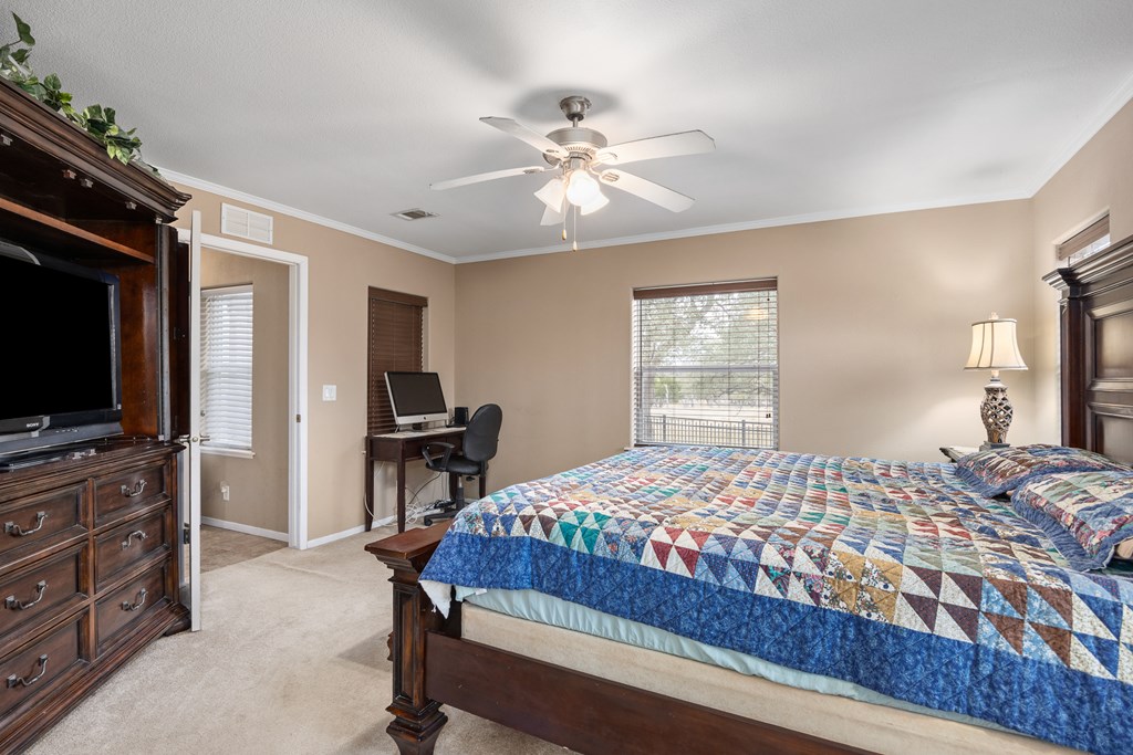 3955 Klein Branch Road Harper, TX 78631 - Photo 16 of 40 a bedroom with a bed and a flat screen tv