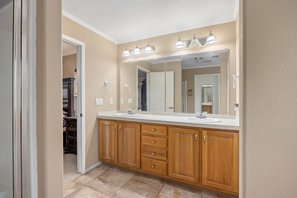 3955 Klein Branch Road Harper, TX 78631 - Photo 17 of 40 a bathroom with a double vanity sink and a mirror