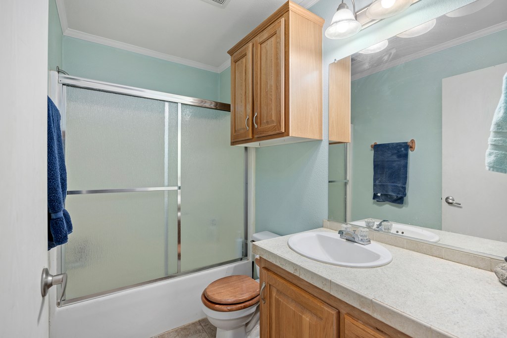 3955 Klein Branch Road Harper, TX 78631 - Photo 21 of 40 a bathroom with a sink toilet and shower