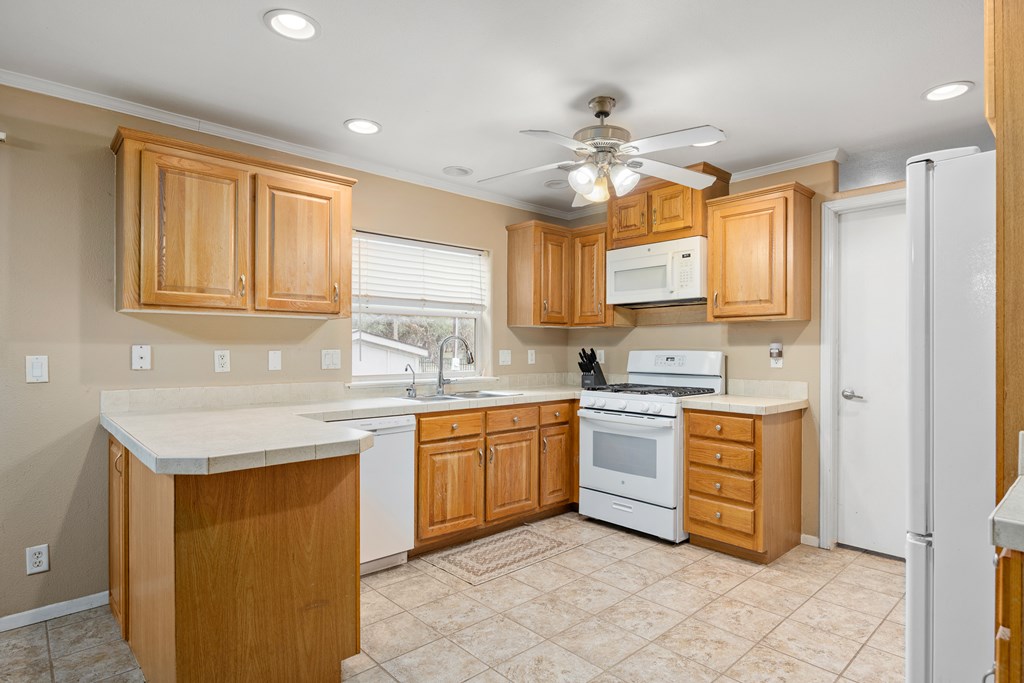 3955 Klein Branch Road Harper, TX 78631 - Photo 10 of 40 a kitchen with a stove a sink and a refrigerator