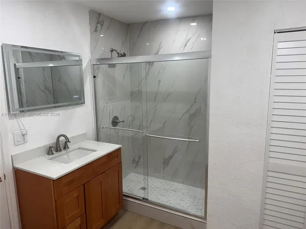 a bathroom with a sink and mirror