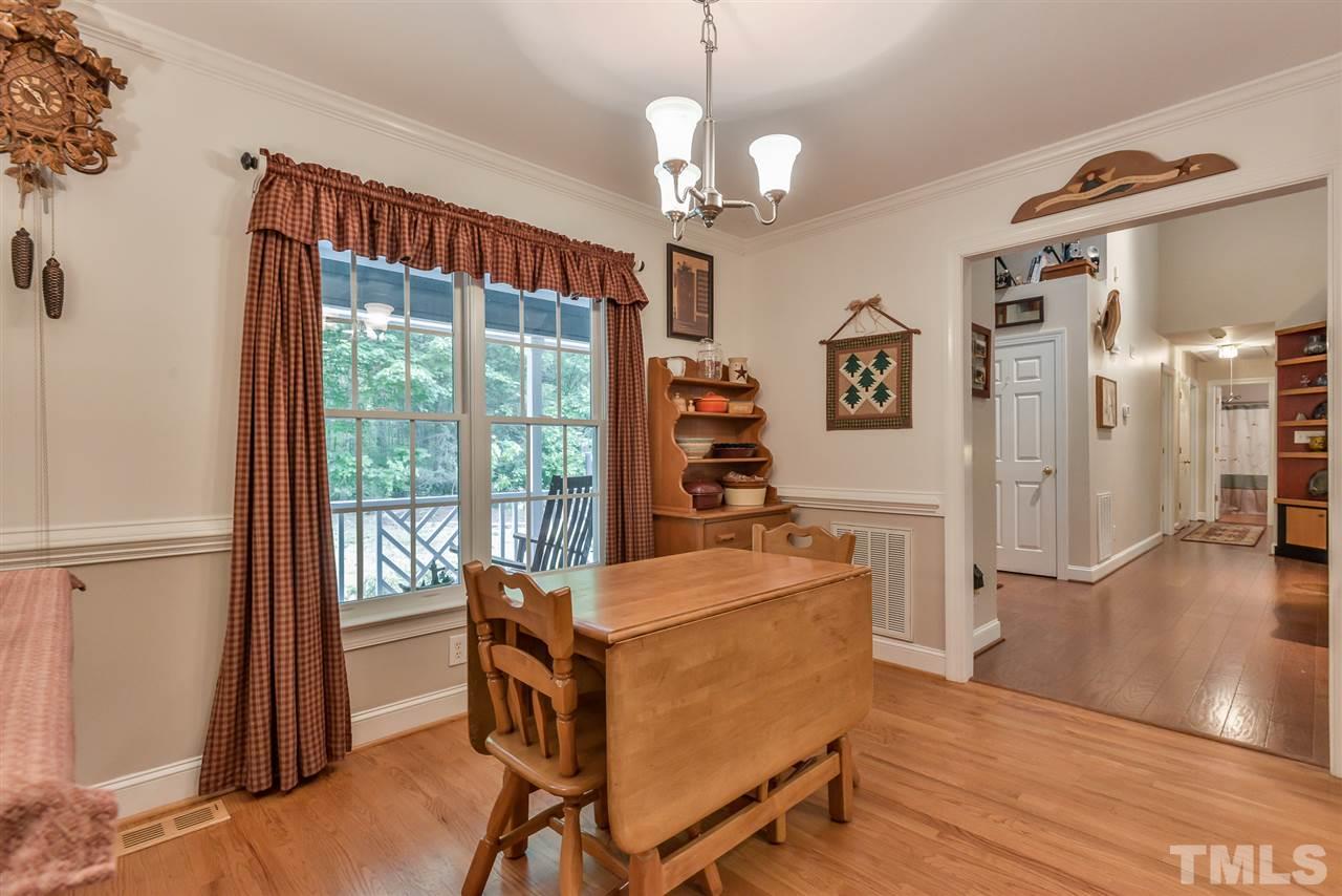 5114 Guess Road Rougemont, NC 27572 - Photo 8 of 22 a dining room with wooden floor and a chandelier