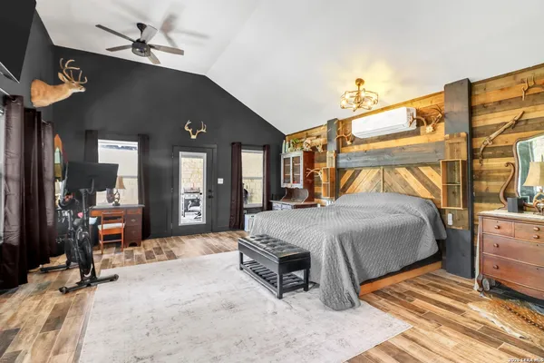 a bedroom with a bed dresser and a mirror