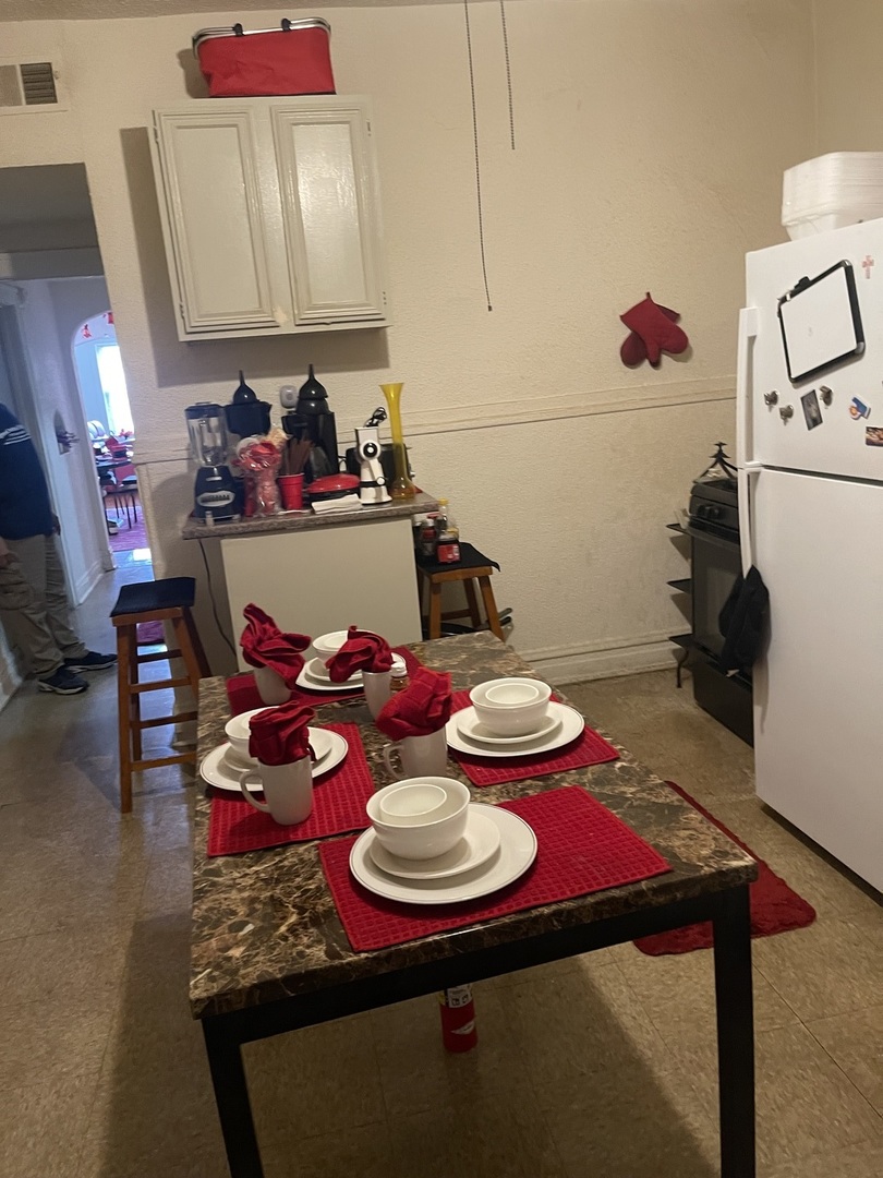 1013 West 63rd Street Chicago, IL 60621 - Photo 14 of 16 a view of a dining room with furniture and a chandelier