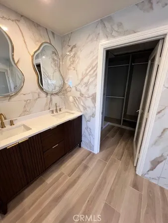 a bathroom with a double vanity sink mirror and