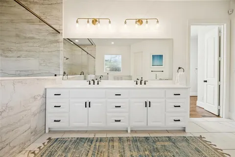 a bathroom with a bathtub and shower