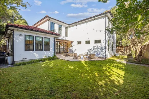 a view of a patio with couches and table and chairs with wooden floor