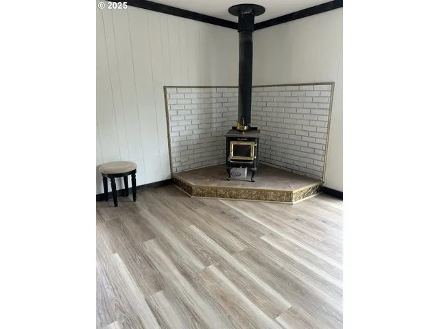 a view of a room with wooden floor and furniture