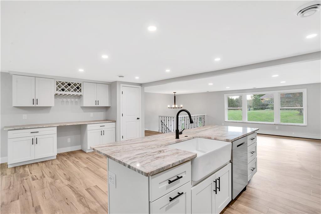 2 Hillcrest Drive Cecil, PA 15321 - Photo 11 of 25 a kitchen with a stove a sink and white cabinets with wooden floor