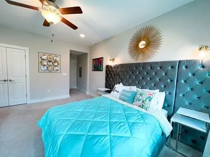 a view of a hallway to a livingroom with furniture