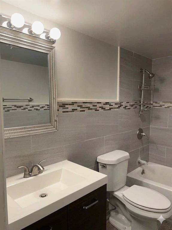 3121 Rosedale Avenue University Park, TX 75205 - Photo 9 of 16 Planned full bathroom featuring a dark wood-finish vanity with an integrated white sink, brushed nickel faucet, and a decorative framed mirror