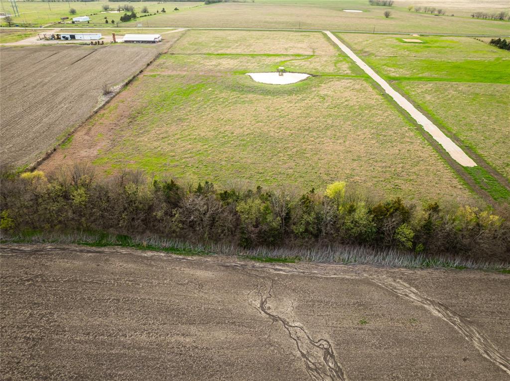 Lot 13 Farm Road Blossom, TX 75416 - Photo 2 of 4 a view of a big yard with an outdoor space