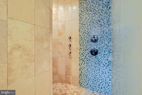 a spacious bedroom with a large bed and a large window