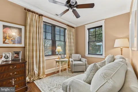 a bedroom with a bed a table and chairs