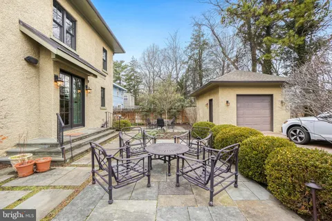 a view of a house with backyard and sitting area