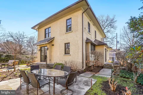 a view of a house with yard and sitting area