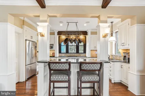 a kitchen with granite countertop a sink and cabinets