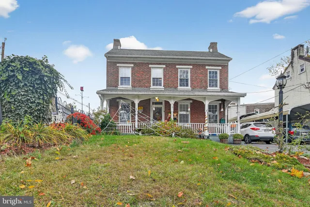 a view of a house with many windows and garden