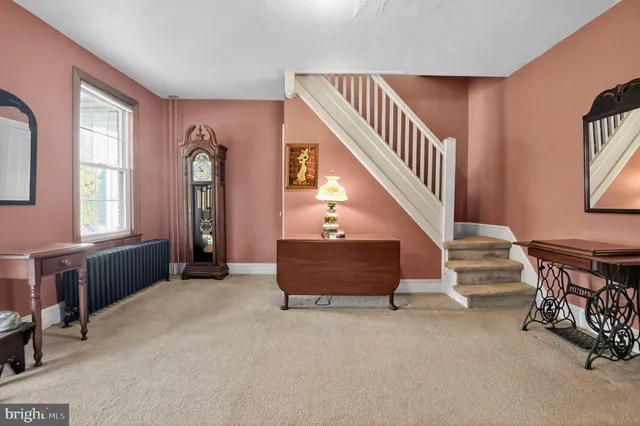 a view of entryway and hall with a front door