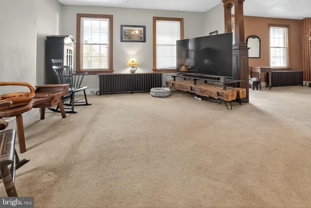 a living room with furniture and a flat screen tv