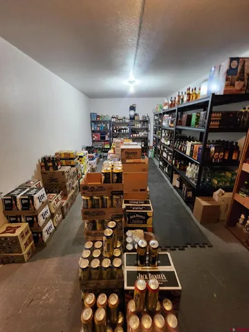 a room with lots of books and a dining table