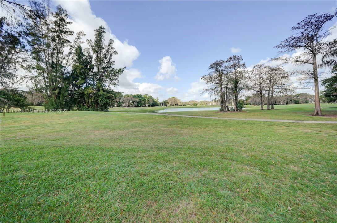 8050 West McNab Road, Unit 216 Tamarac, FL 33321 - Photo 1 of 16 a backyard of a house with lots of green space
