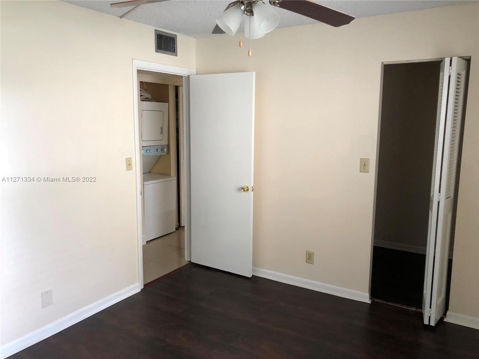 8050 West McNab Road, Unit 216 Tamarac, FL 33321 - Photo 13 of 16 an empty room with wooden floor