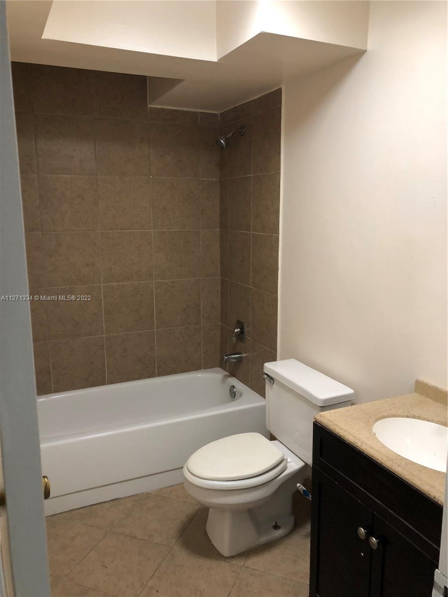 8050 West McNab Road, Unit 216 Tamarac, FL 33321 - Photo 14 of 16 a bathroom with a toilet a sink and bathtub
