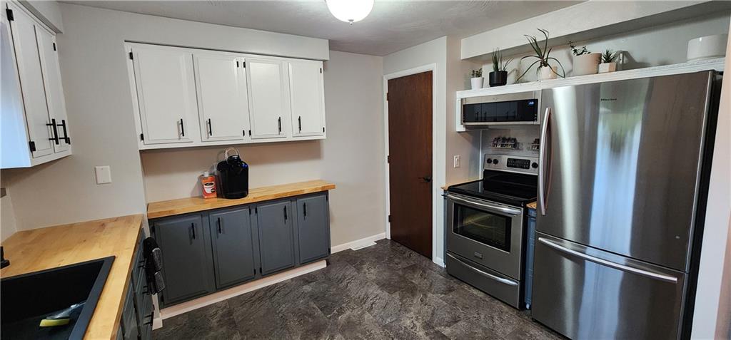4833 Lucerne Road Indiana, PA 15701 - Photo 5 of 16 a kitchen with stainless steel appliances granite countertop a refrigerator and a sink