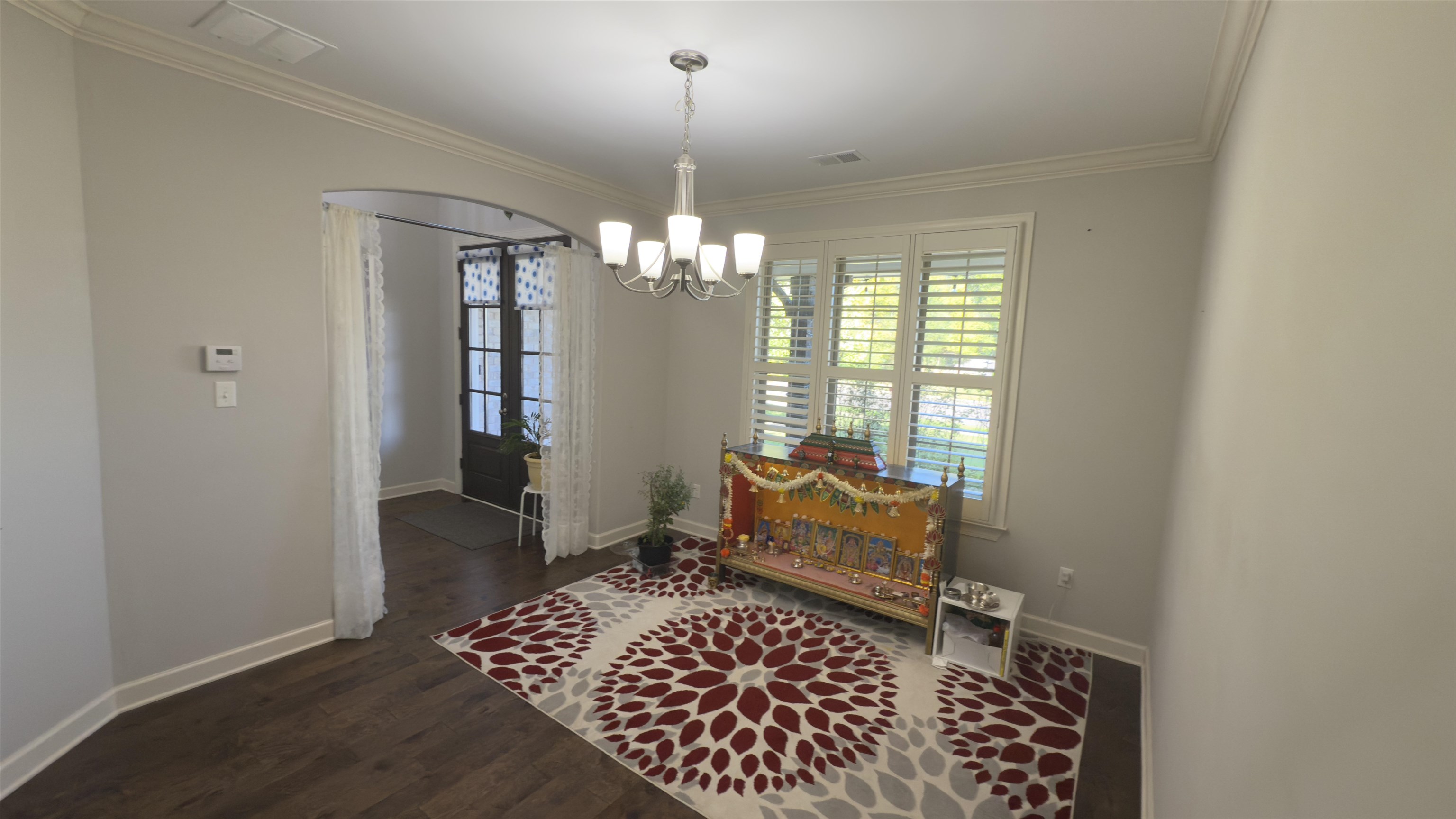 1217 Pilgrim Ridge Road Collierville, TN 38017 - Photo 16 of 33 Sitting room featuring dark wood-style flooring, crown molding, and a chandelier