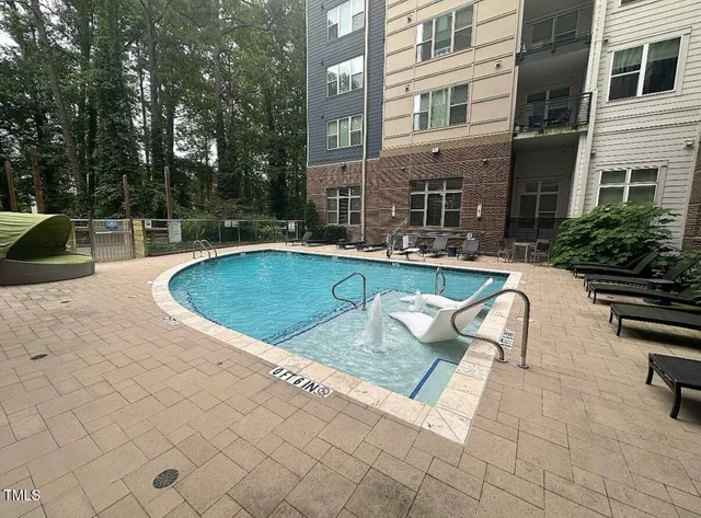 a view of swimming pool with outdoor seating and plants