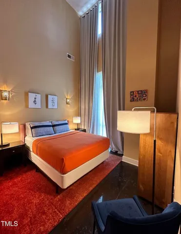 a bed room with a bed and a night stand