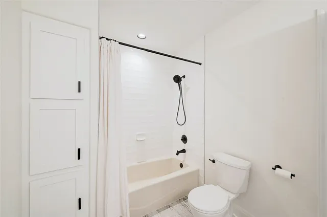 a bathroom with a toilet and a shower