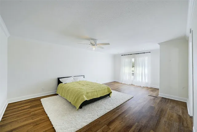 a bedroom with a bed and a night stand