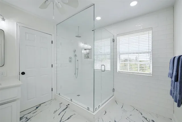 a bathroom with a shower and a sink