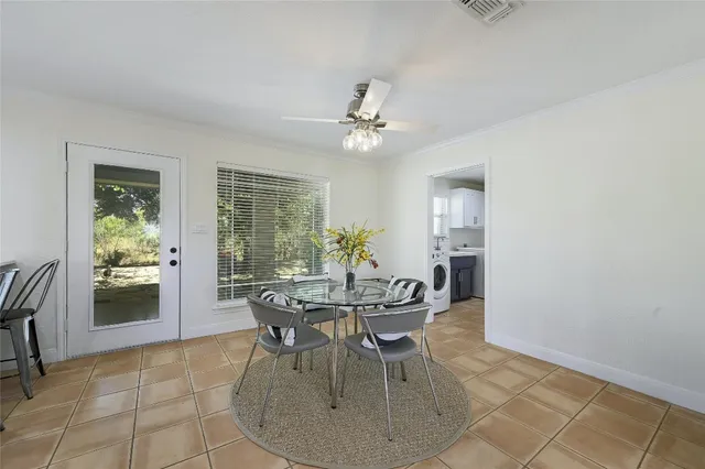 a view of a dining room with furniture and a chandelier