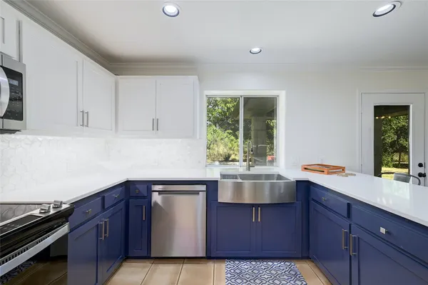 a kitchen with a sink and cabinets