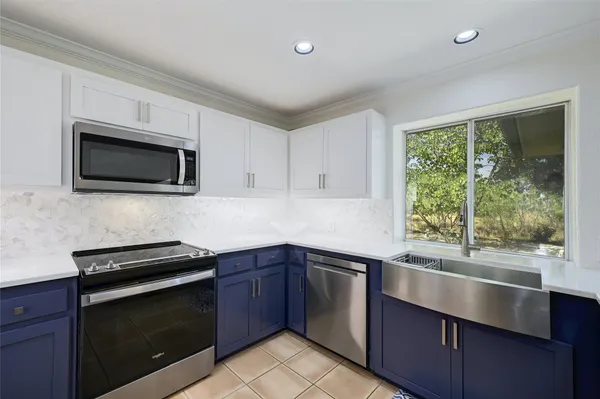 a kitchen with a sink and a microwave