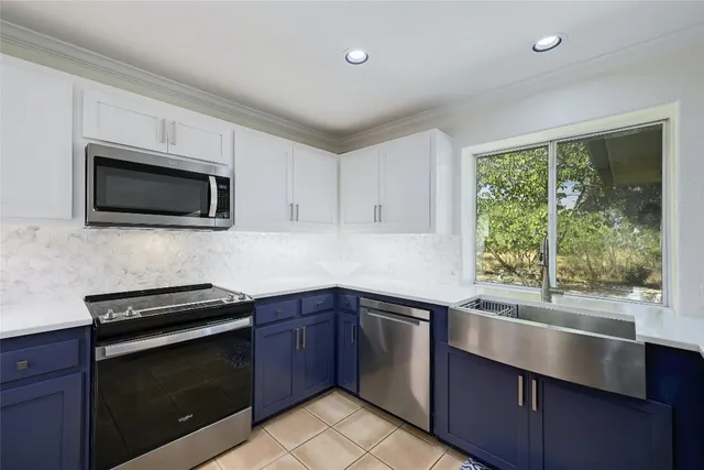 a kitchen with a sink stove and microwave